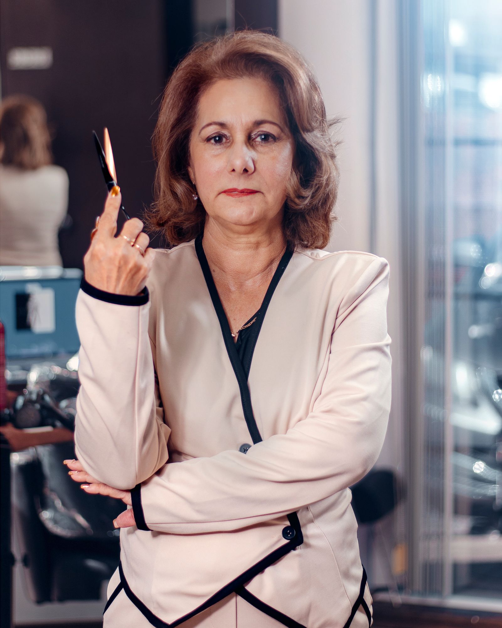 Editorial portrait of a hairstylist holding scissors